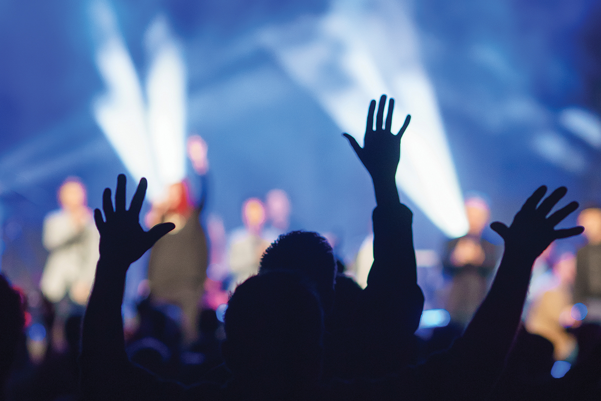 People raising their hands during a concert