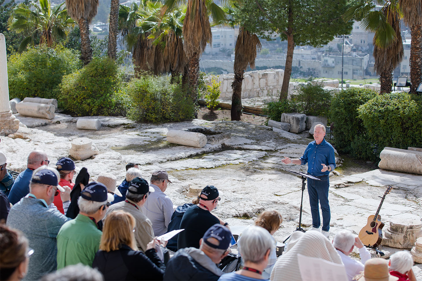 Max Lucado speaking to a crowd sitting on the Southern Steps in Israel