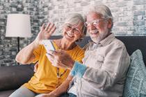 Smiling, older couple looking at a cell phone screen