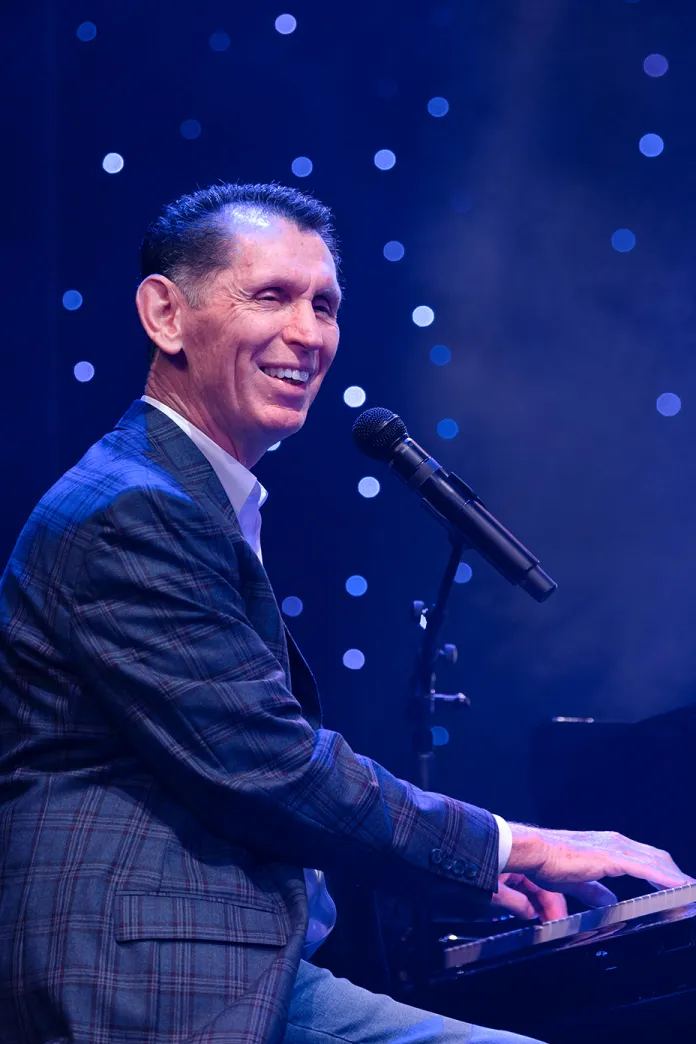 Tim Lovelace sitting at a piano