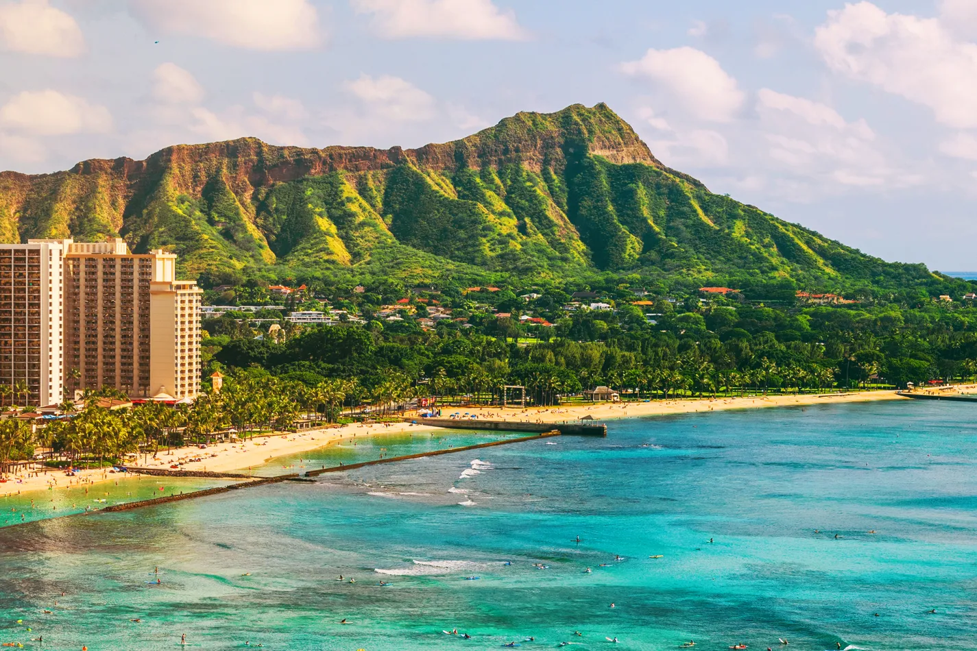 Waikiki Beach with turquoise water, beachfront hotels, and Diamond Head crater in the background.