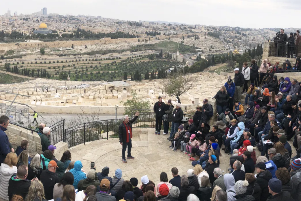 Jack Graham speaking to a large group of people with the city of Jerusalem in the background