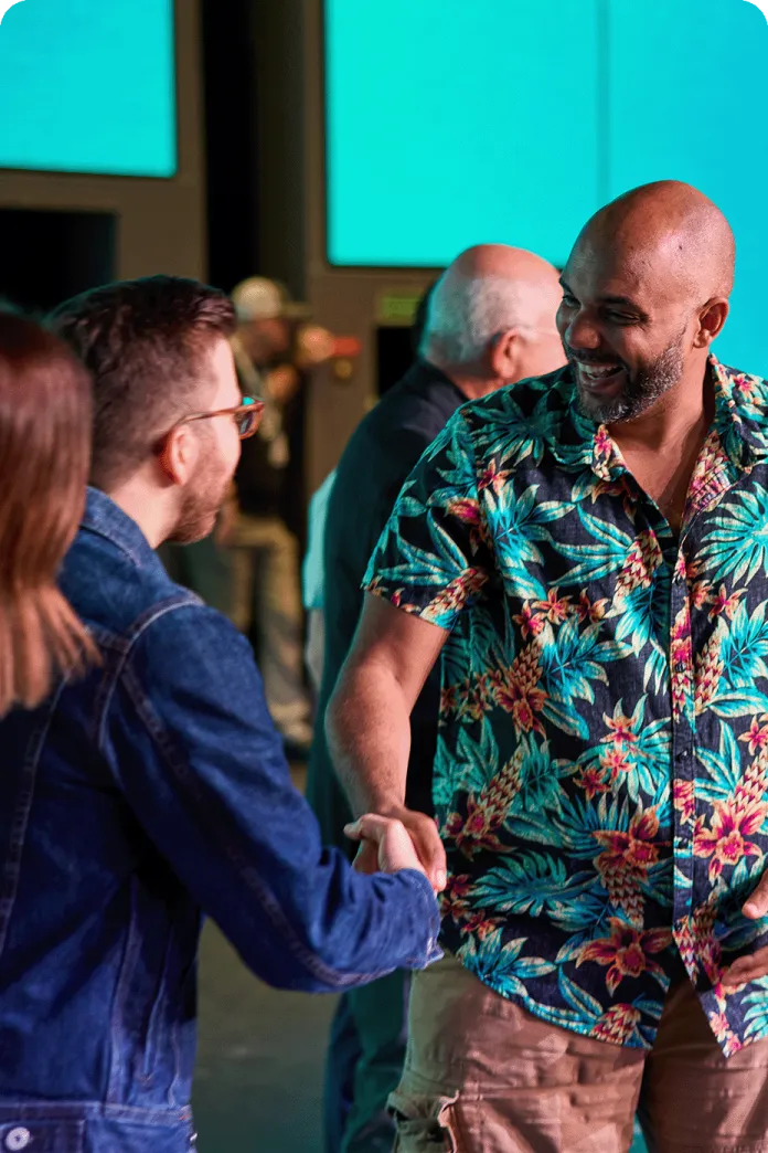 Two men smiling and shaking hands