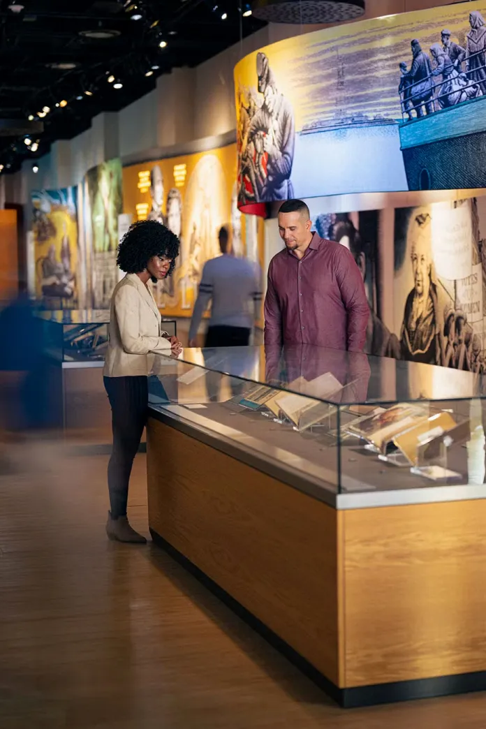 People looking at books and documents in a museum