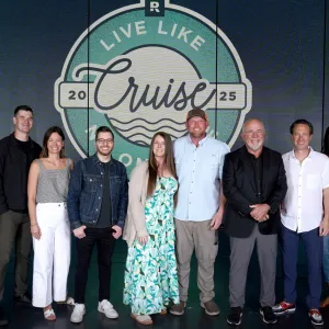 The Ramsey Personalities standing with travelers on the Live Like No One Else cruise