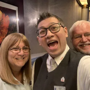 Three joyful people taking a selfie