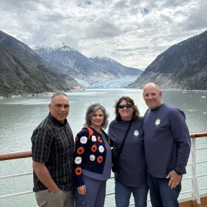 Group of travelers with the water and mountains in the background