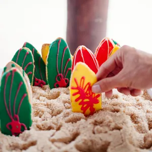 Colorful cookies decorated and shaped like surf boards